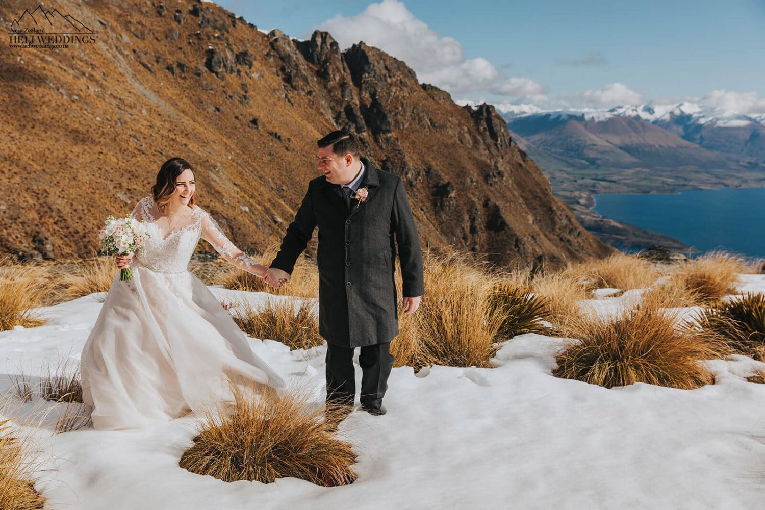 Wedding couple walking in snow on The Ledge, Queenstown heli wedding package
