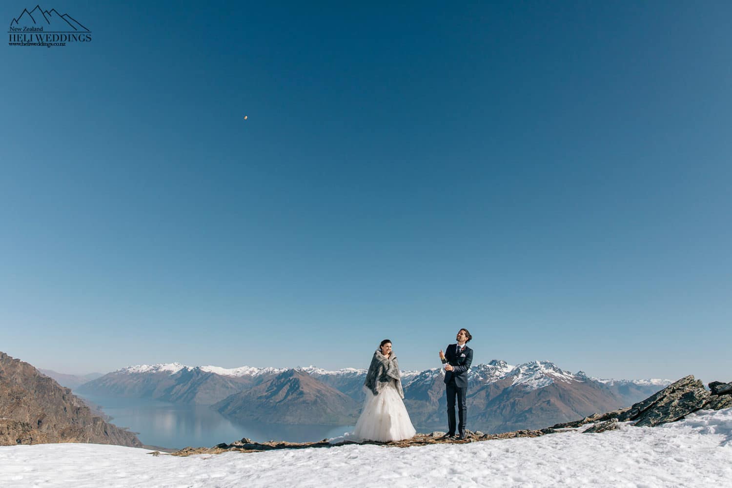 Bride and groom in the snow on the Remarkables