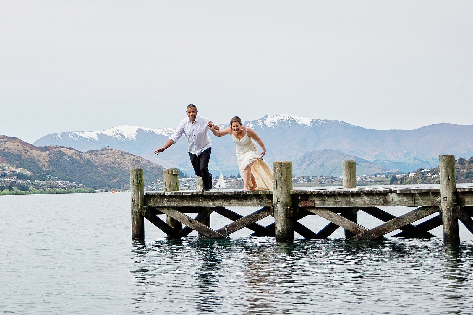 Wedding couple jump into the lake