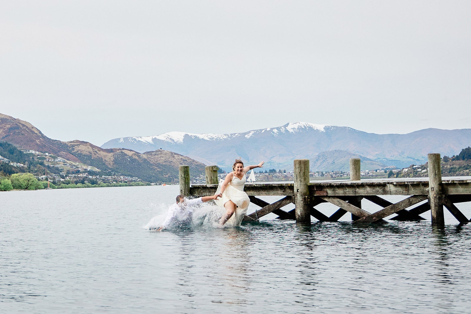 Wedding couple jump into the lake