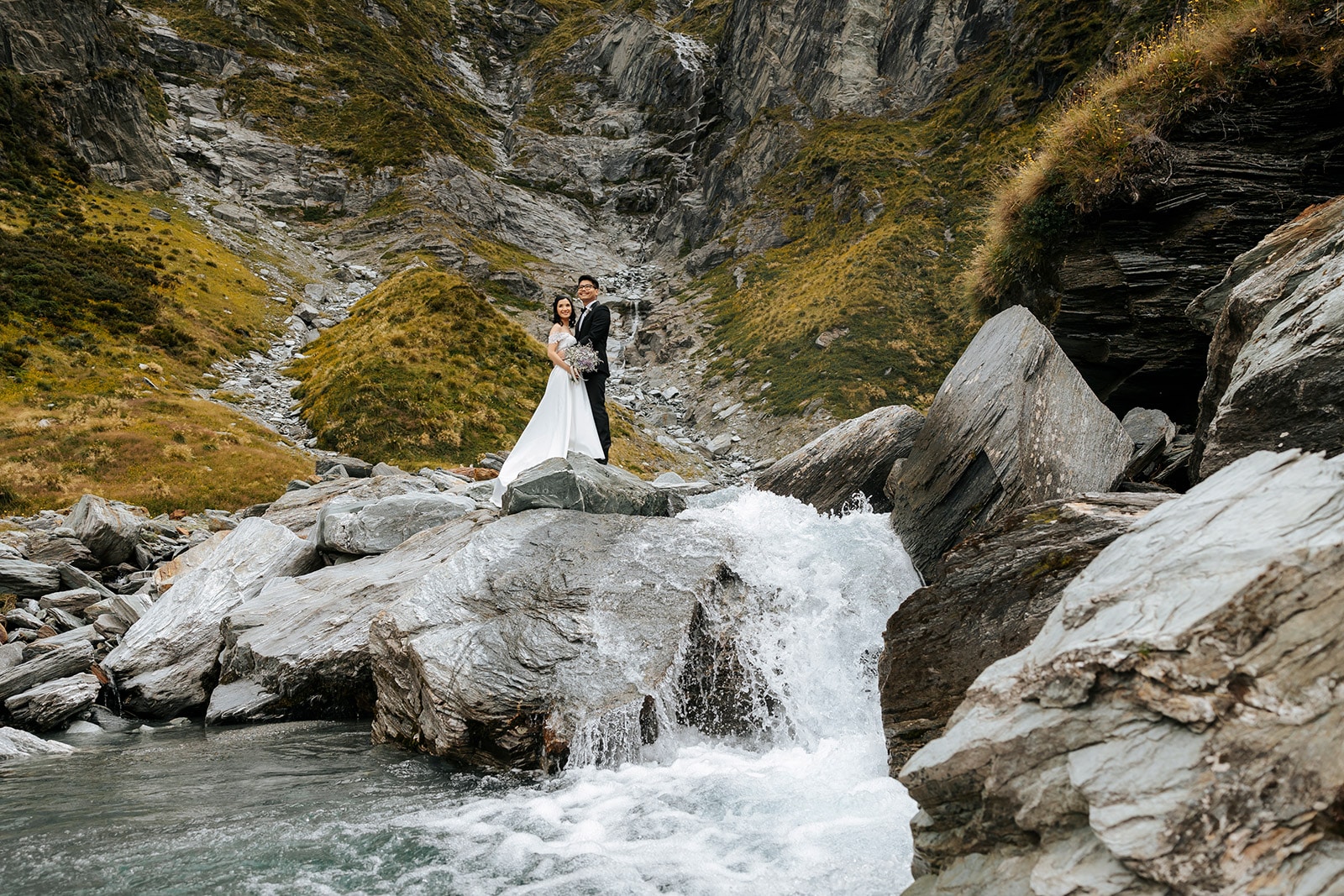 Heli Wedding ceremony at Lochnagar in Queenstown, bride and groom with waterfall in the background