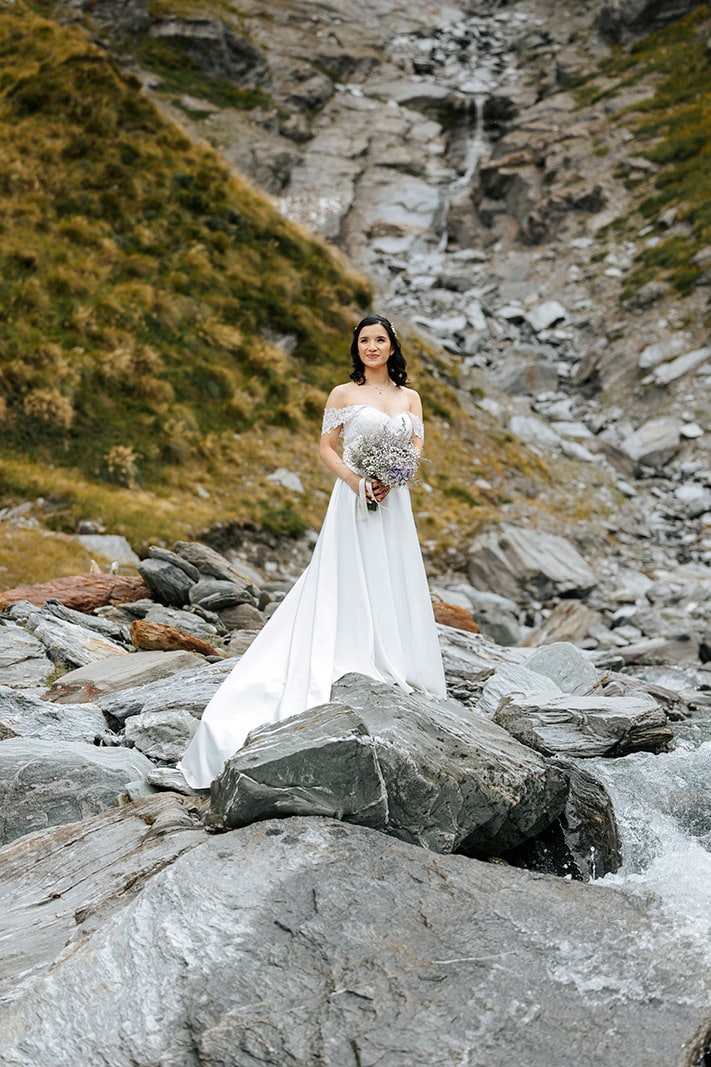 Heli Wedding ceremony at Lochnagar in Queenstown, bride with waterfall in the background